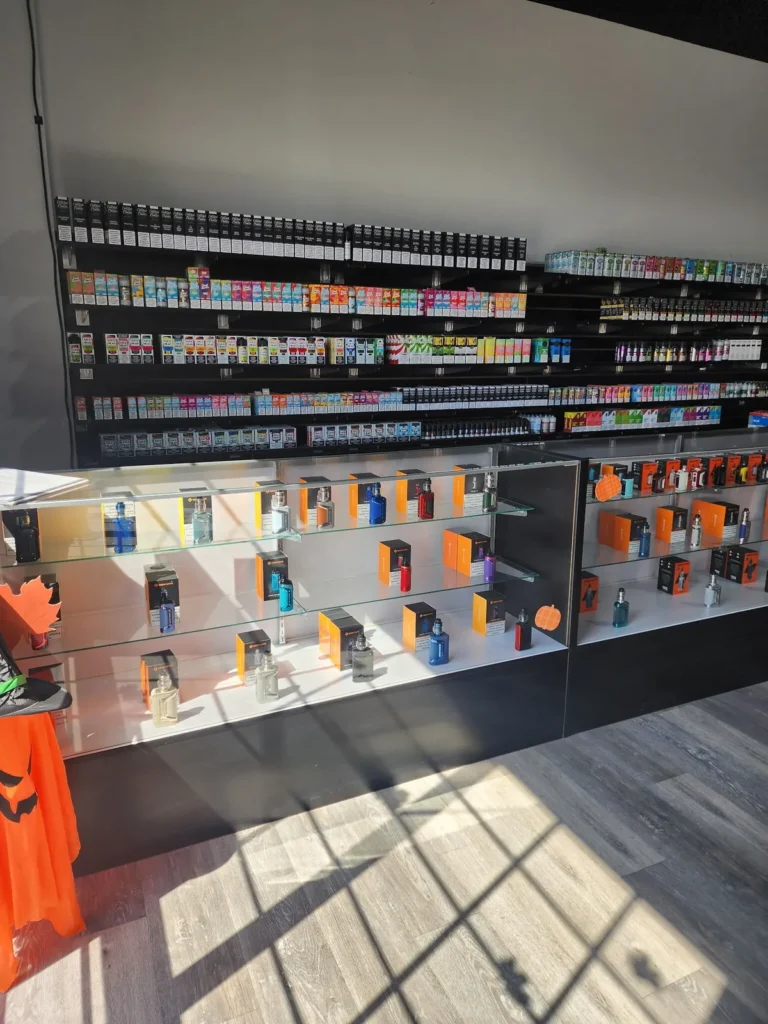 Box mods in a glass case under an e-liquid wall