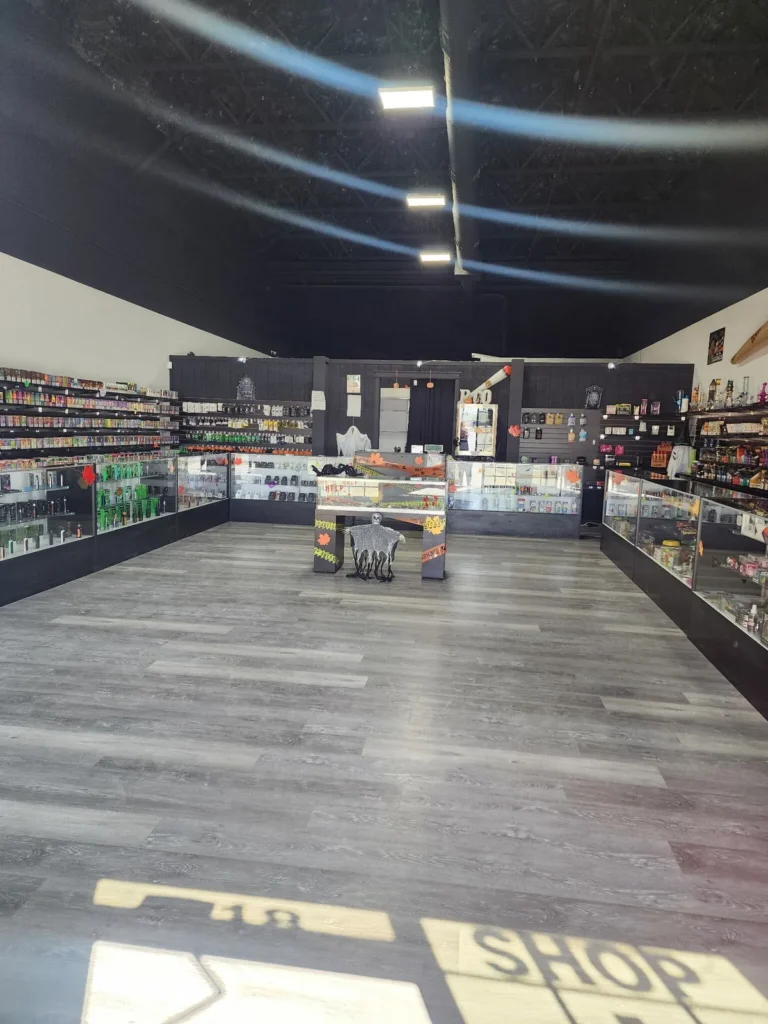 Inside a Premium Vapor Company store, glass cases along both walls