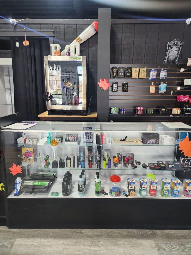 Glass case with cart batteries, dab tools and CBD products