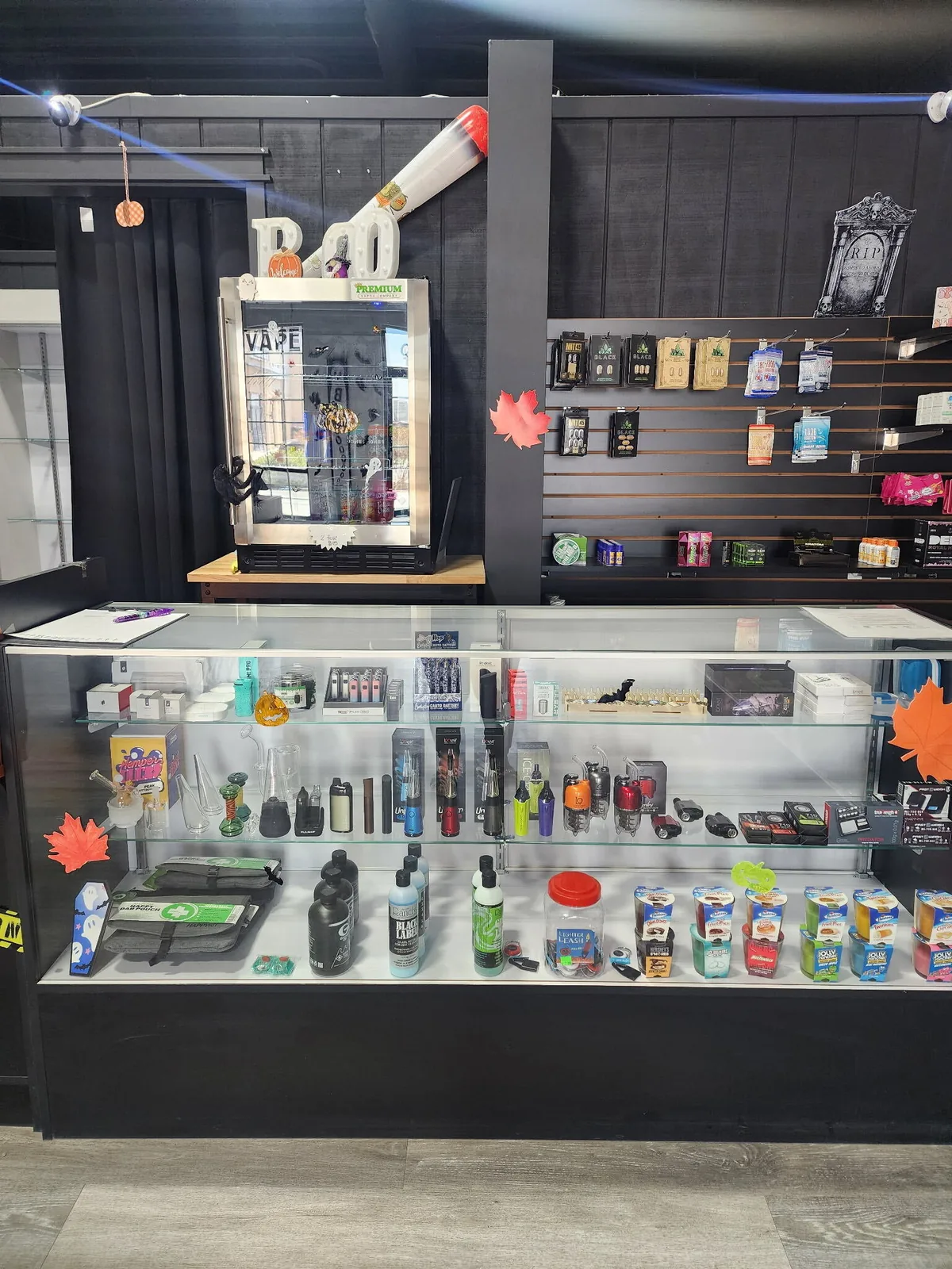 Glass case with cart batteries, dab tools and CBD products